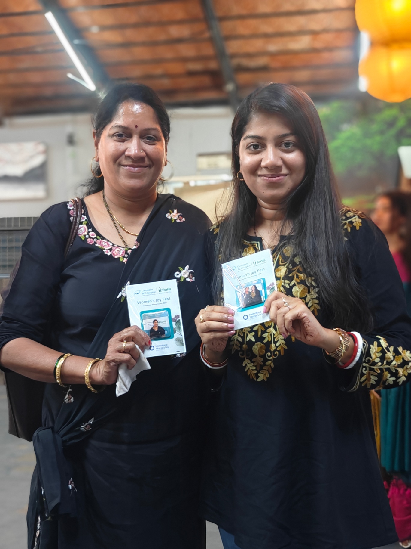 Guests showing their Women's Day photo magnets